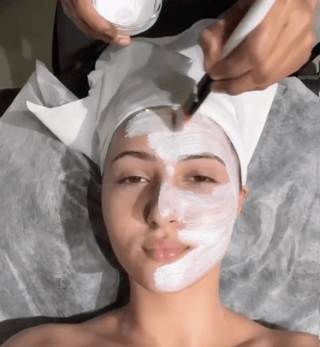 Woman receiving facial treatment at Leor clinic
