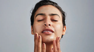 Woman applying moisturizer, glowing skin care