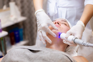 Woman receiving laser facial treatment